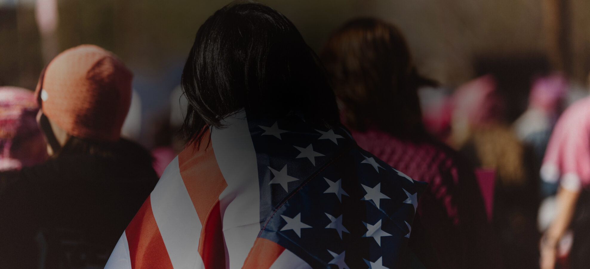 woman with American flag draped around her shoulders