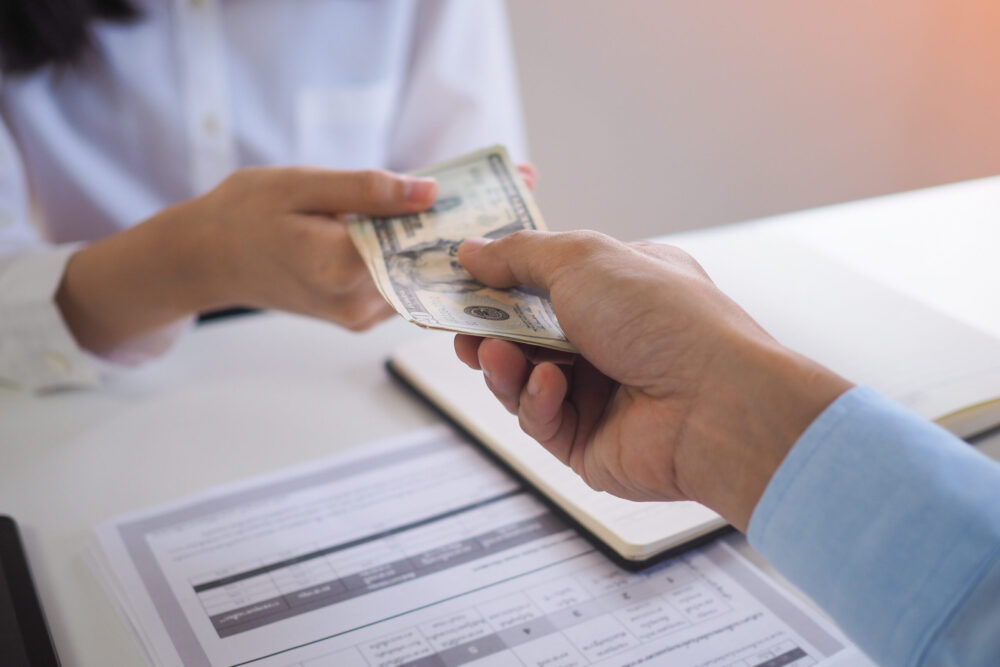 hands exchanging cash